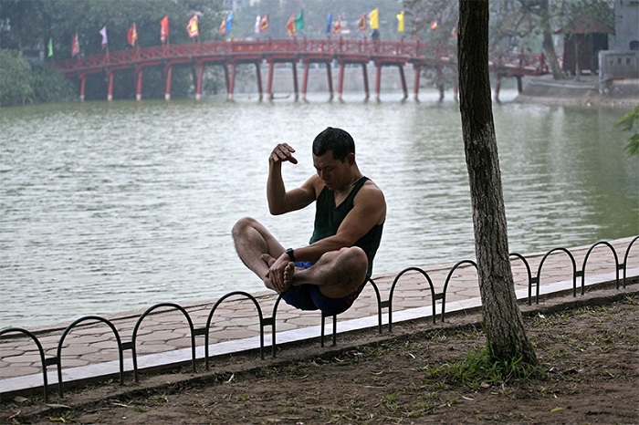 visit hanoi in early morning a man in the lake